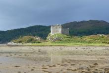 Castle Tioram and the beach at Dorlin at low tide in Autumn
